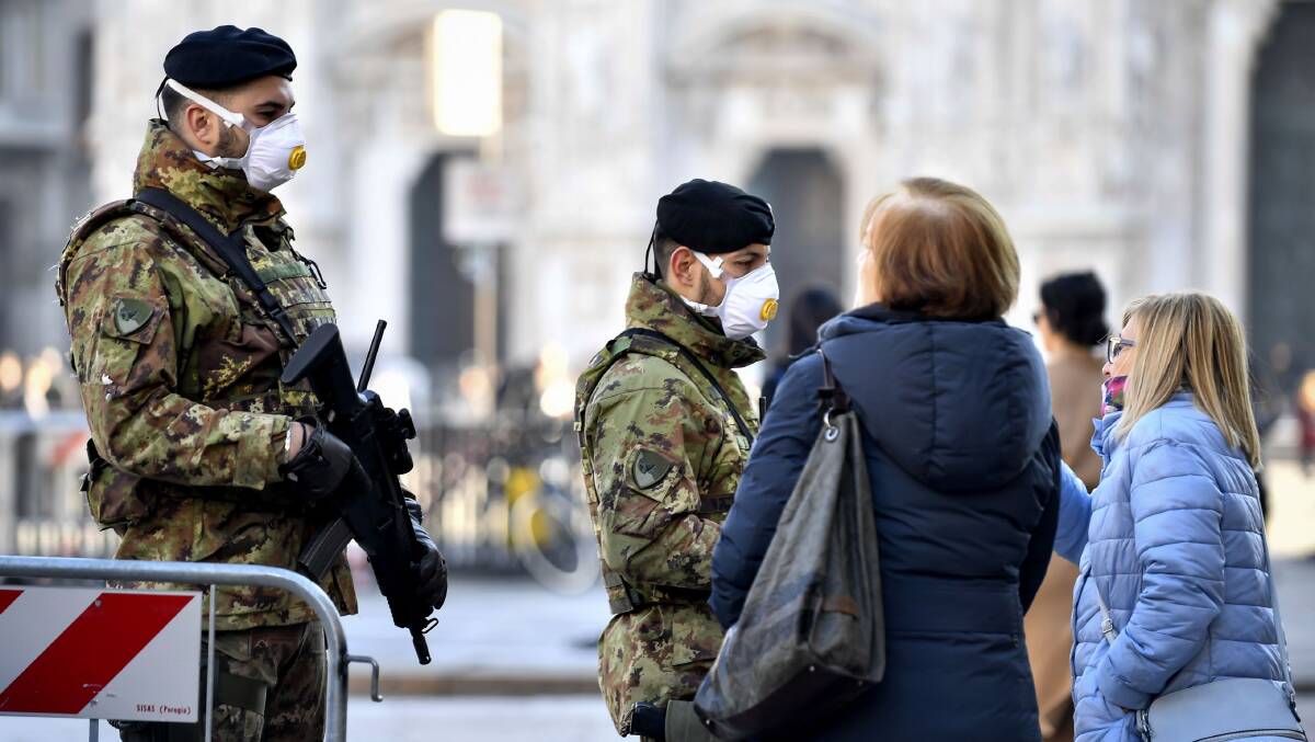Military officers wearing face masks stand outside Duomo cathedral in Milan, closed by authorities due to a coronavirus outbreak. Picture: Shutterstock