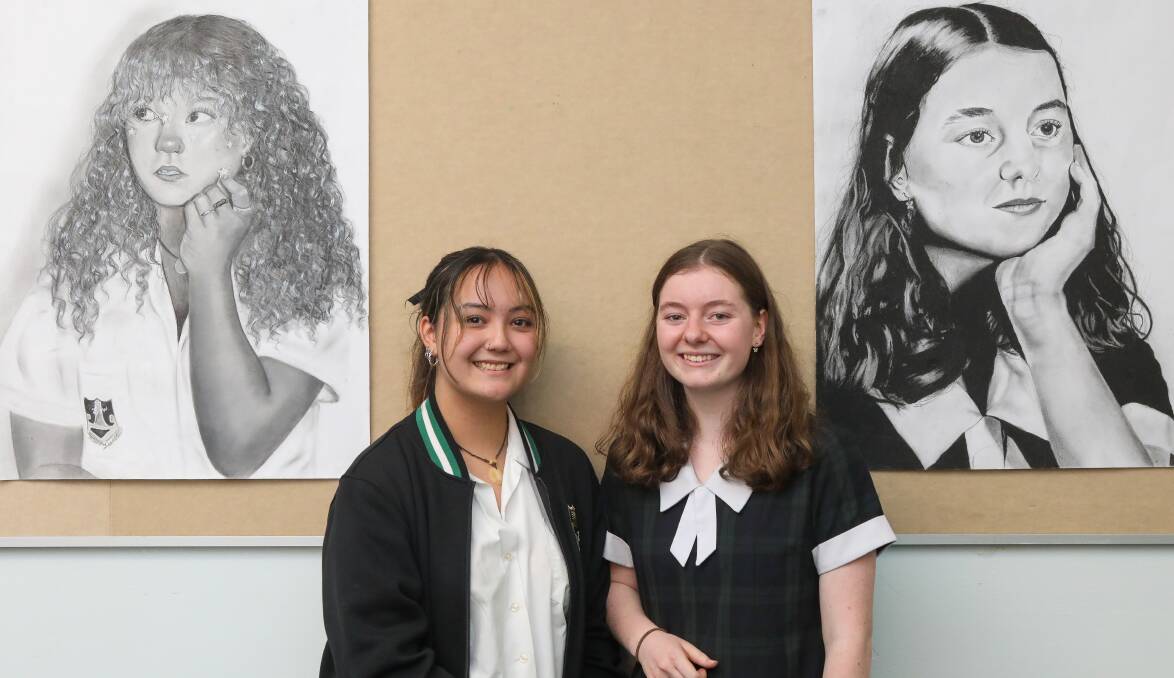 Year 11 students Dechen Sherpa and Natalie Greenlees and their charcoal self-portraits at Wollongong High School of the Performing Arts. Picture by Adam McLean