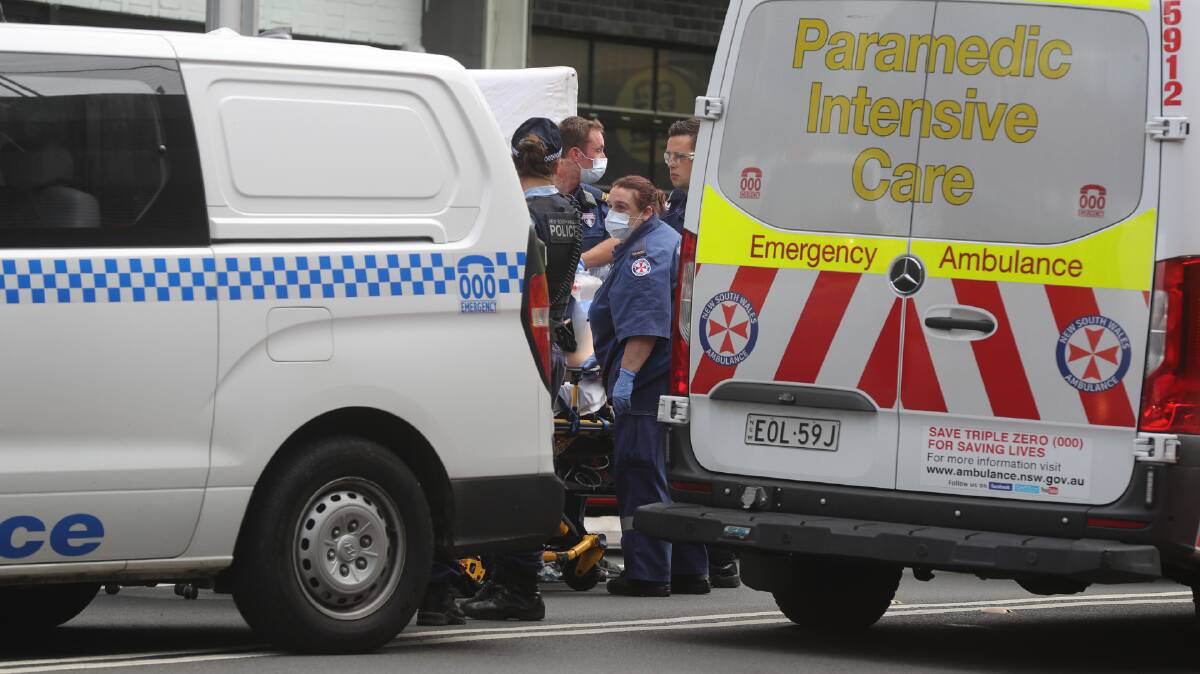 Paramedics and police at the scene of a serious incident in Wollongong on Monday.
