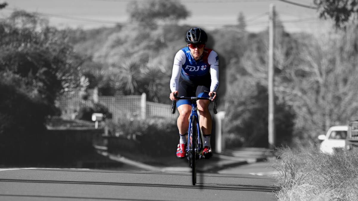 Olympic cyclist Grace Brown rides up Dumphries Avenue in Mount Ousley ahead of the Wollongong 2022 UCI Road World Championships. Picture: Anna Warr, digitally altered.