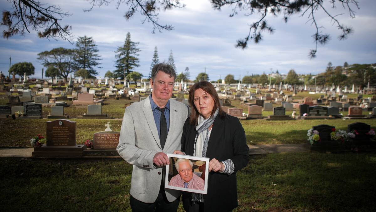 Ian and Jane Carratt at the grave of Jane's father, Kevin Whalan, in Kiama cemetery. Picture: Adam McLean