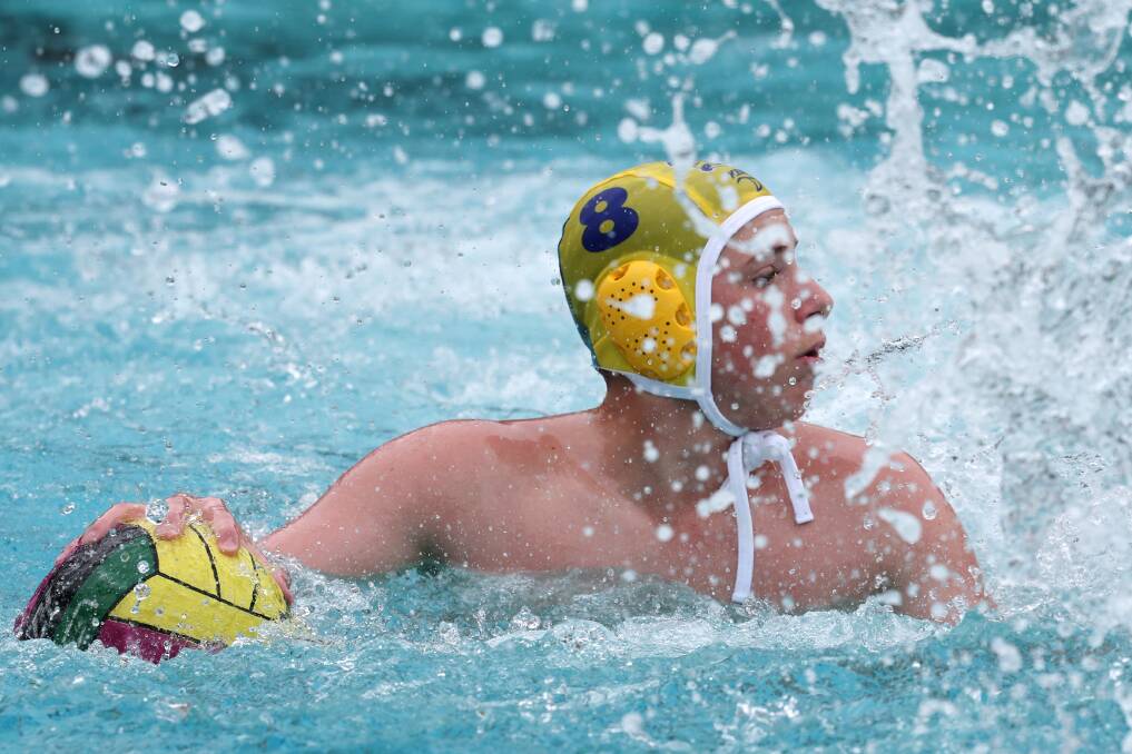 November 24. Ben Hutchens looks for teammate options down the pool during the NSW Combined High Schools water polo tournament action from the South Coast v North West game at UOW pool.