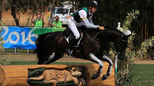 Christopher Burton of Australia riding Santano II clears a jump during the Cross Country Eventing. Photo: Mike Ehrmann