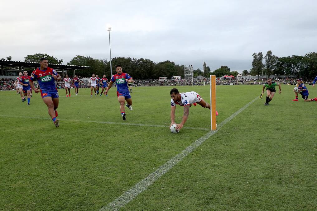 Touchdown: Jordan Pereira grabs one of four tries in the Dragons trial win over Newcastle. Picture: NRL Photos