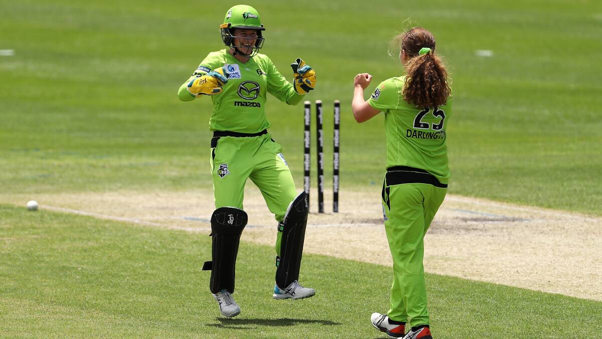 Safe hands: Albion Park's Tahlia Wilson celebrates a wicket with Thunder teammate Hannah Darlington during last year's WBBL. Picture: Mark Kolbe/Getty Images