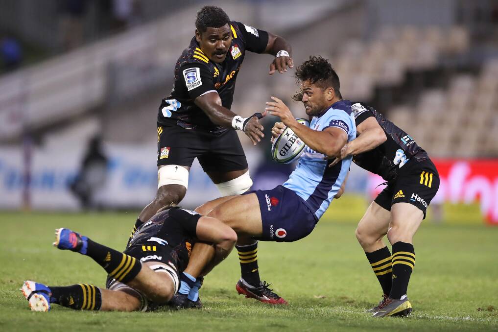 Tough outing: Waratahs centre Karmichael Hunt is tackled during Friday night's loss to the Chiefs. Picture: Getty Images/Mark Kolbe.
