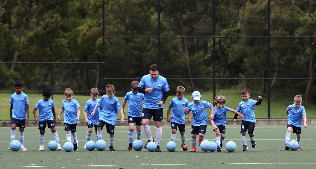 New passion: Casey puts Illawarra juniors through their paces in a Sydney FC clinic. Picture: Sylvia Liber