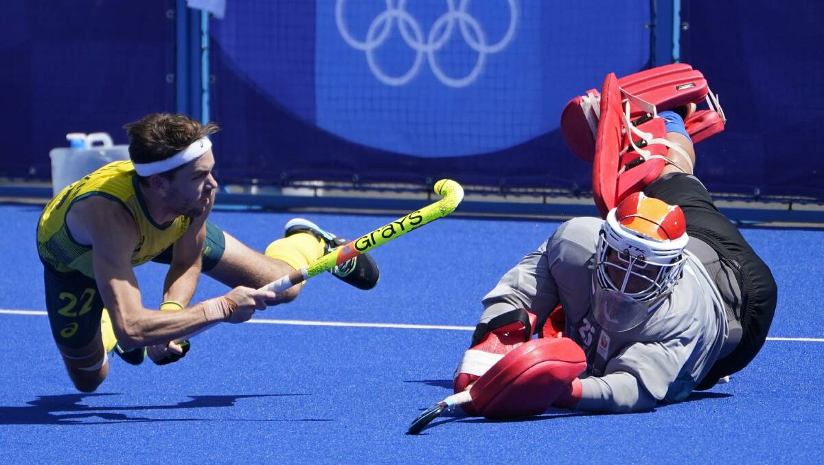 Clutch play: Flynn Ogilvie scores to put Australia up 2-0 in Sunday's penalty shootout. Picture: John Minchillo/AP