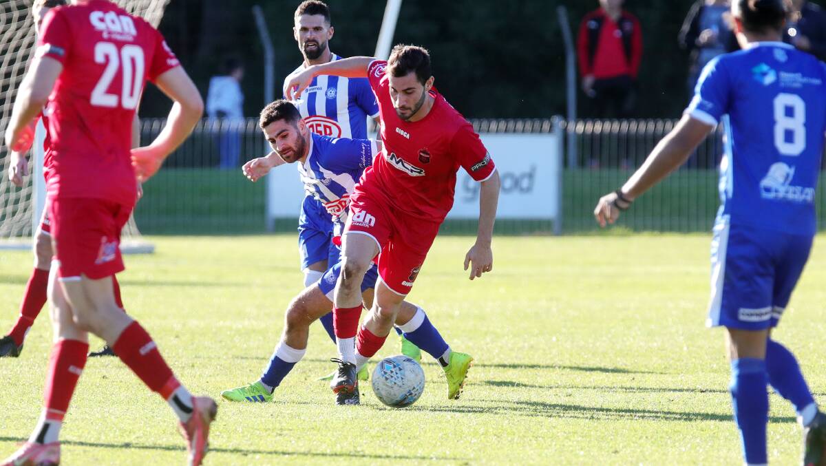 Tough outing: Ethan Kambisios attempts to evade a Sydney Olympic defender during Sunday's loss. Picture: Sylvia Liber