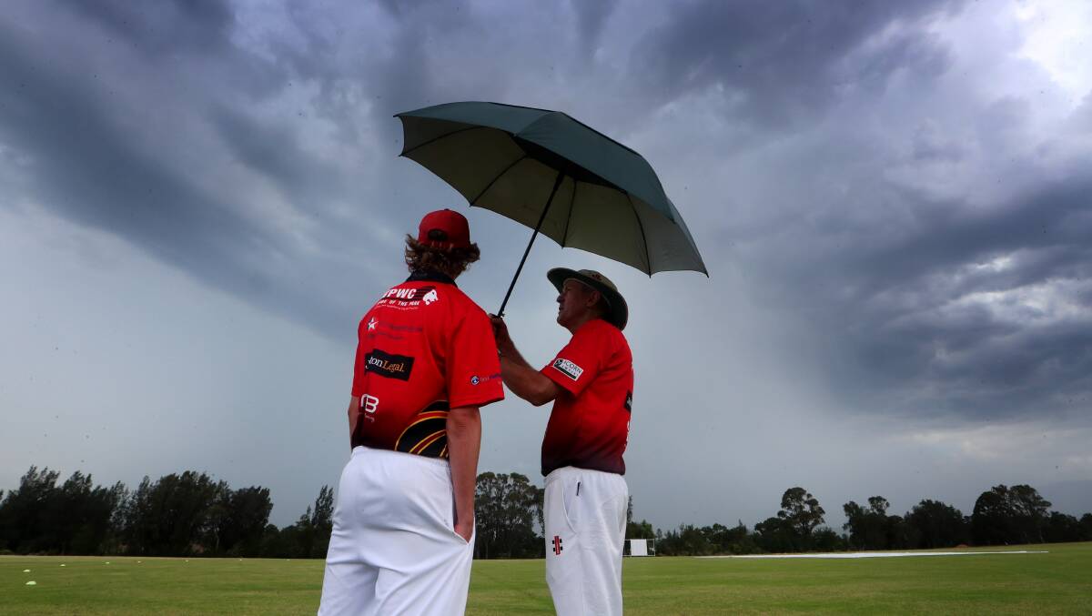 Finals hopes washed away: Tom Jeffery and Doug Murphy look on as the rain falls at Reed Park. Picture: Sylvia Liber. 