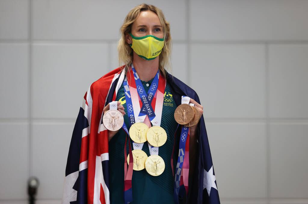 Excess baggage: Emma McKeon with the seven medals she won at the Tokyo Olympic Games. Picture: James Chance/Getty Images