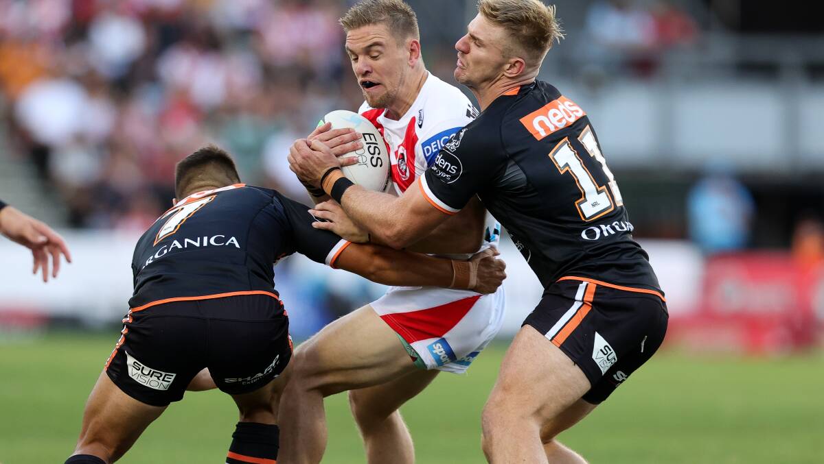 Battered: Matt Dufty is tackled during Sunday's loss to the Tigers. Picture: Speed Media/Icon Sportswire via Getty Images