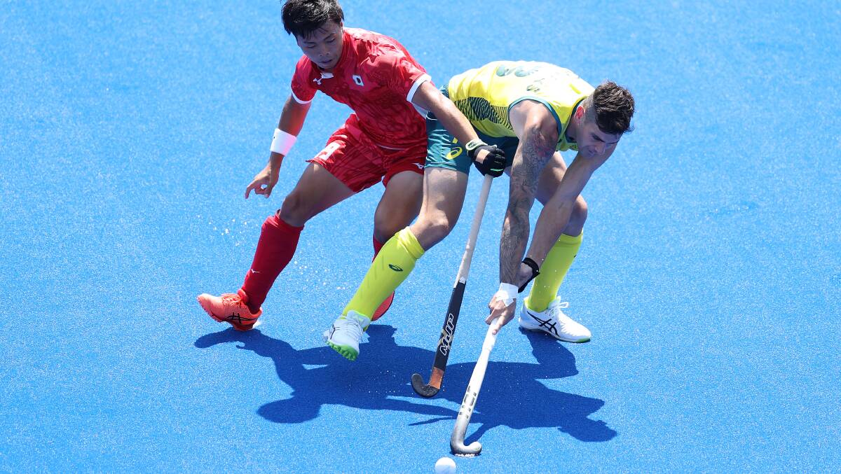 Hard fought: Blake Govers battles for possession during the Kookaburras victory over Japan. Picture: Dan Mullan/Getty Images