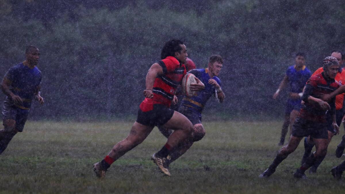 Mud bath: Tech's Eli Sinoti finds clear air in driving rain during Saturday's win over Avondale. Picture: Sylvia Liber