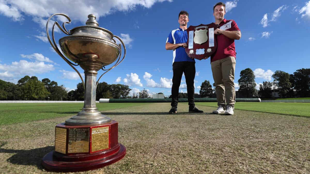Rivals: University's James Chappell and Wollongong's Nathan Loveday with the Cricket Illawarra trophies they will play for on Saturday. Picture: Robert Peet