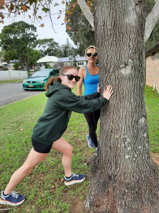 Warming down: Jess Hogg and sprinter Lisa Quinn stretch after a solid 5km run. Picture: Valmai Loomes