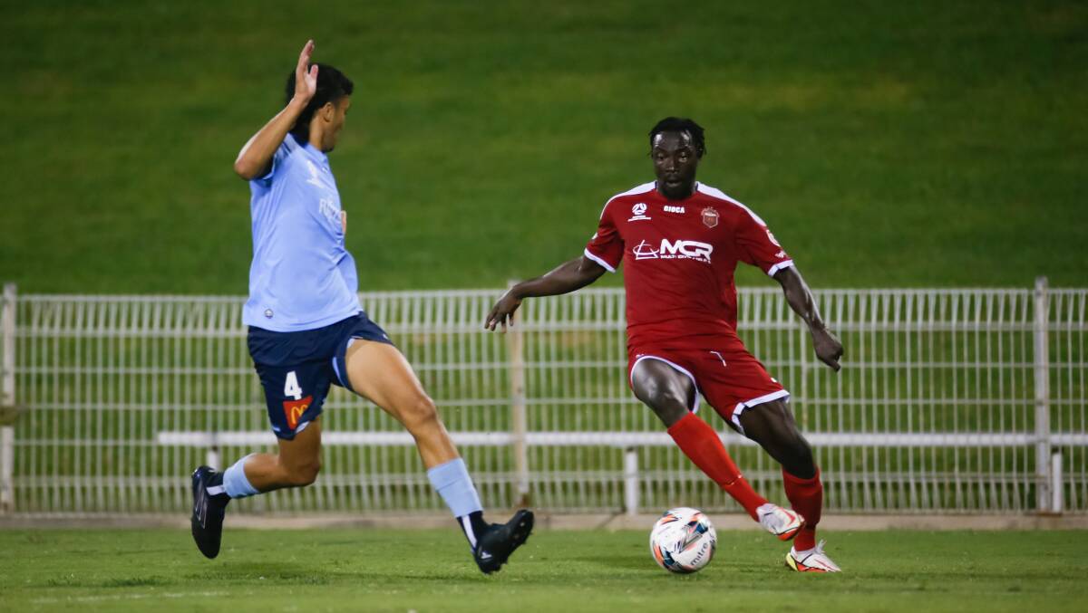 Silky skills: Kuot Maliet scored his first goal for the Wolves in Friday's draw with Sydney FC. Picture: Anna Warr