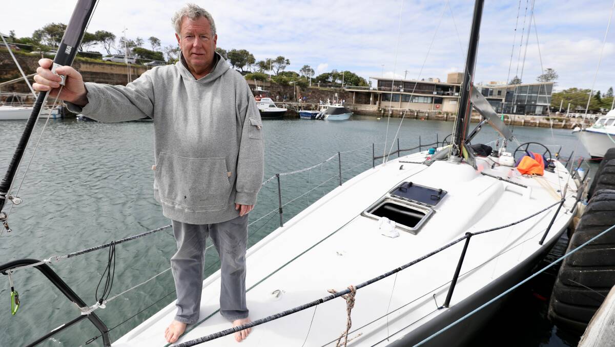 Rough ride: Damien Parkes assesses the damage to Denali in Wollongong Harbour after the boat was forced to withdraw from the Sydney to Hobart. Picture: Adam McLean