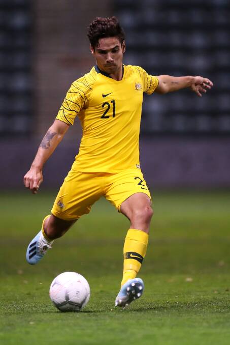 On home turf: Wollongong's Tate Russell in action for the Olyroos. Picture: Getty Images.