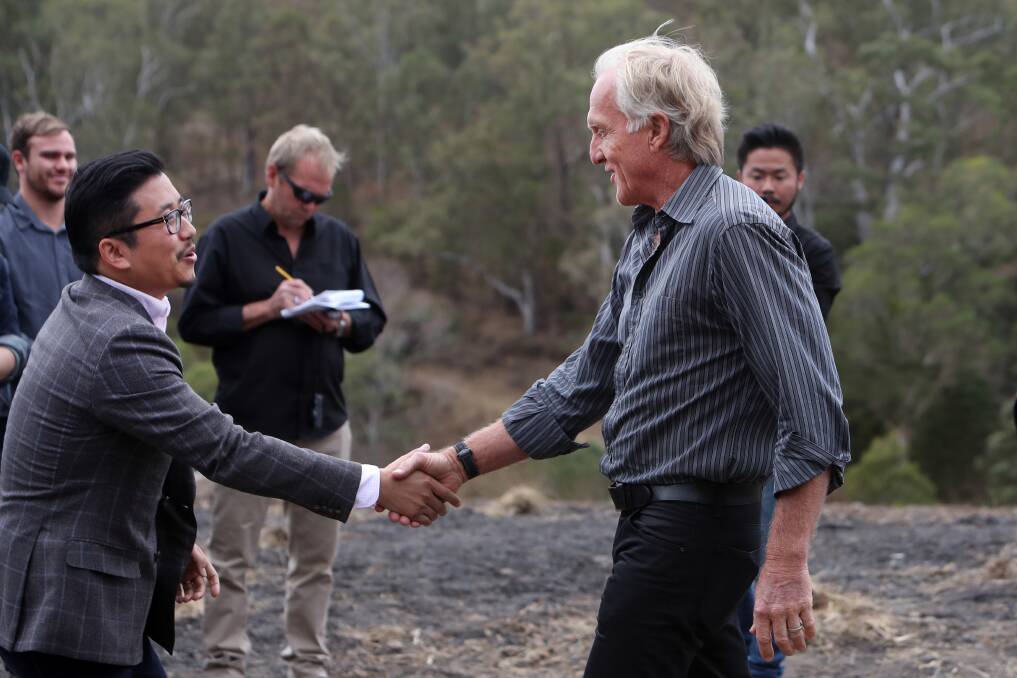 Big expectations: VIG's Michael Guo shakes hands with Greg Norman at the Silkari at Avondale groundbreaking ceremony in 2017. Picture: Sylvia Liber.