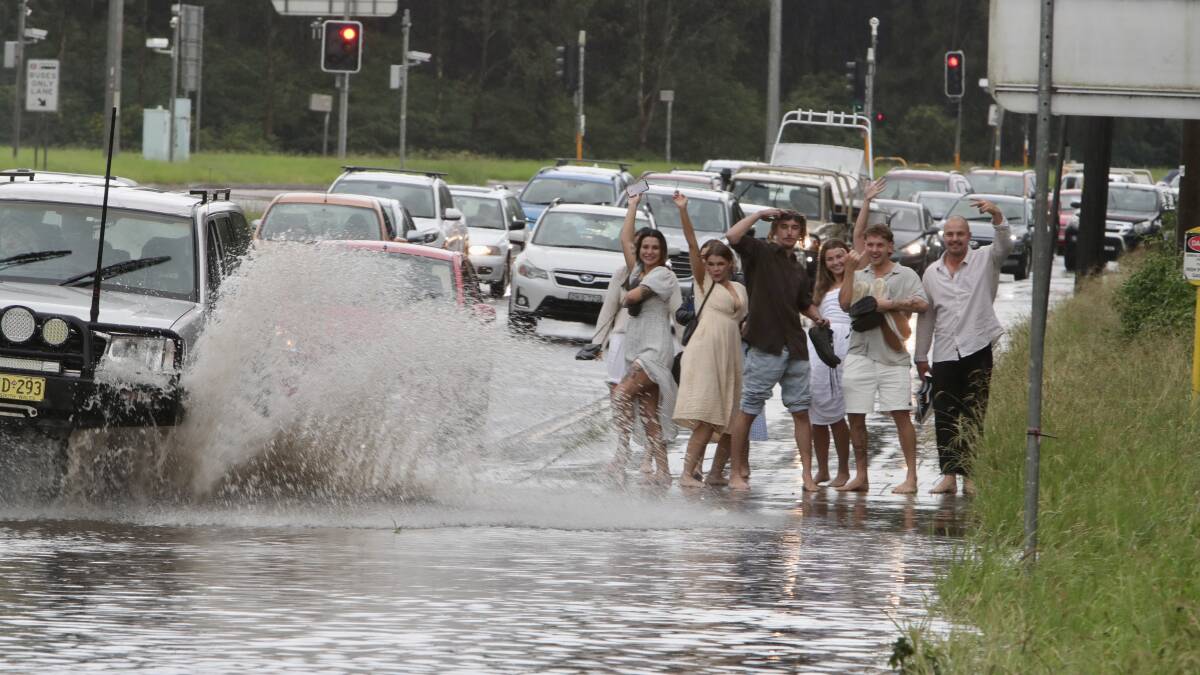 Despite being drenched, barefooted and splashed by the spray from passing cars, they were all smiles as they posed and captured the experience on their own phones. Pictures: Sylvia Liber.