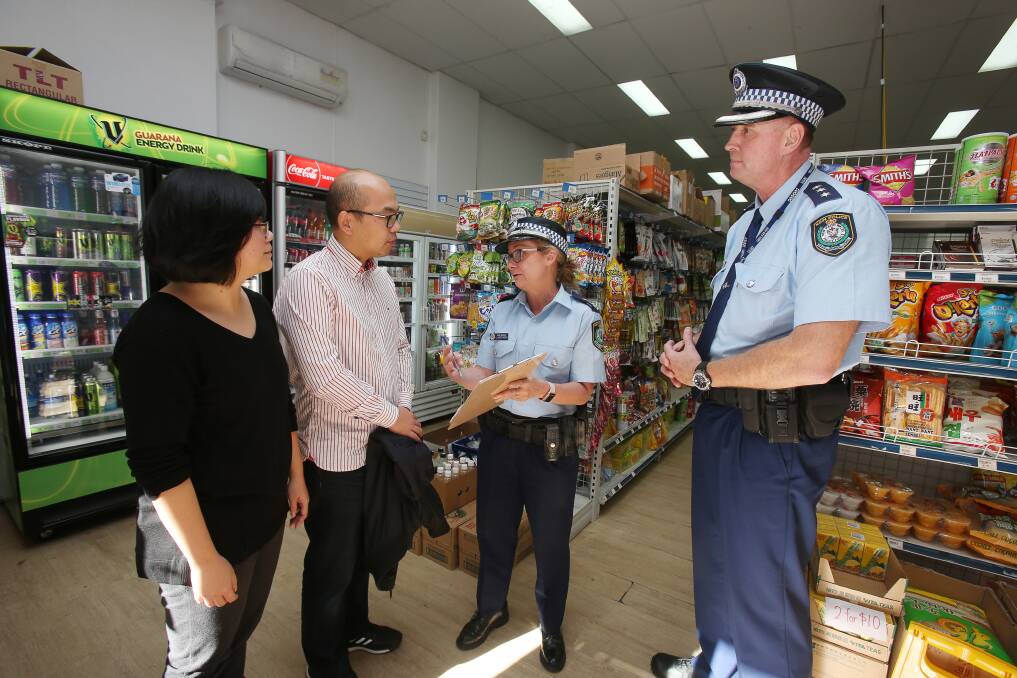 Simple steps: Jiang Jiang Xu and Peng Zhang hear from police about safety measures. Picture: Robert Peet.