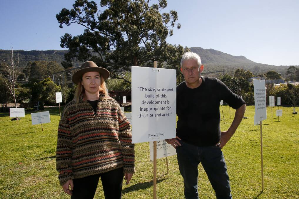 COVID-friendly protest: Stephen Le Bas and Louise Wellington were up at 4am hammering in the signs, which are a "silent protest" against the massive Thirroul Plaza development plans. 