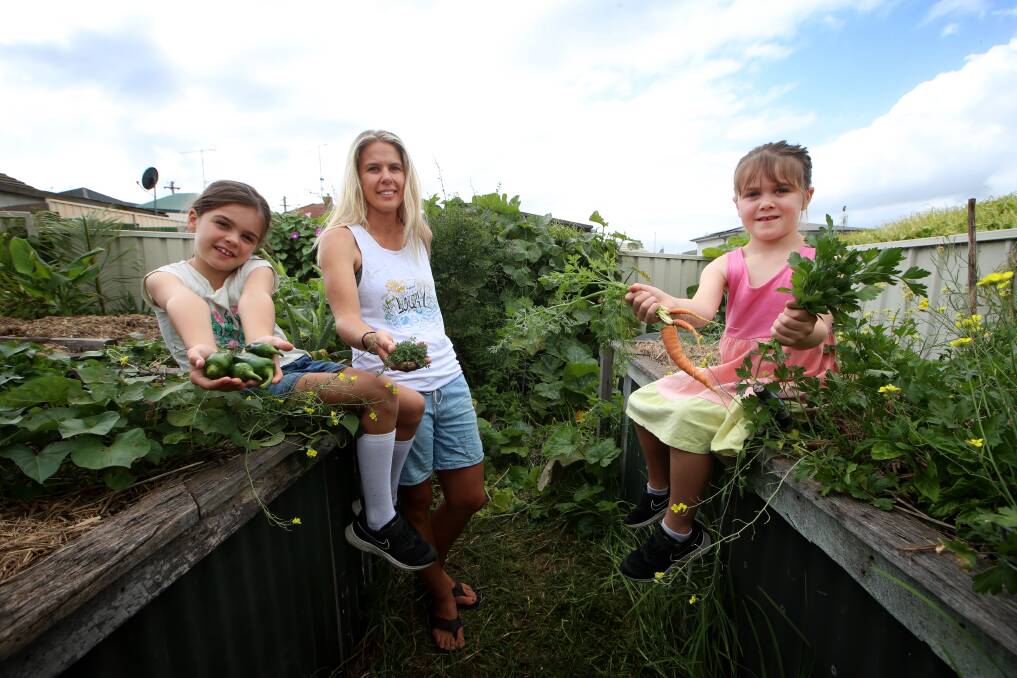 Double the benefits: Jess Whittaker and daughters Abigail and Rose have rediscovered their veggie patch in a big way in recent weeks. Picture: Sylvia Liber.
