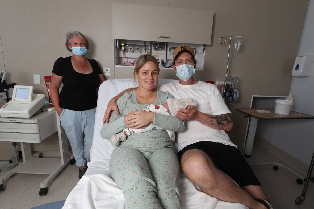 Freeway delivery: Brittney McCauley and James Nathaniel with their newborn son, Alby, who was born on the M1 Motorway on Wednesday morning, with the help of midwife Kylie Hazelton. Picture: Robert Peet.