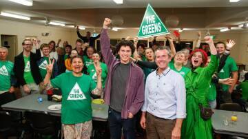 Vote growth: Greens candidates Dylan Green (centre) and Jamie Dixon (right) celebrate the party's gain in vote share. Picture: Anna Warr