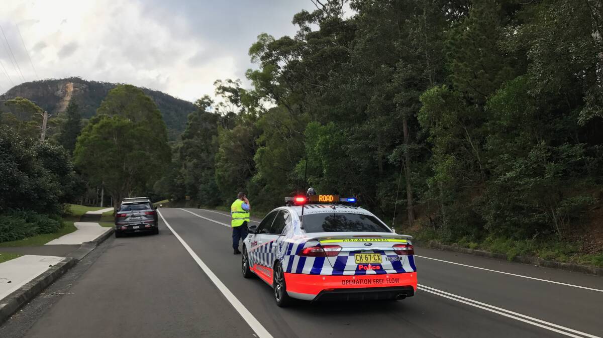 Police blocked off Mount Keira Road to allow the ambulance rescue helicopter to land at the archery park. Picture: Georgia Matts.