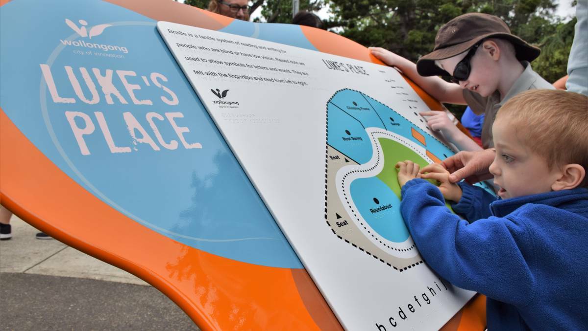 POPULAR INCLUSION; Children check out the new Braille sign at Luke's Place in Corrimal. Picture: Wollongong City Council.