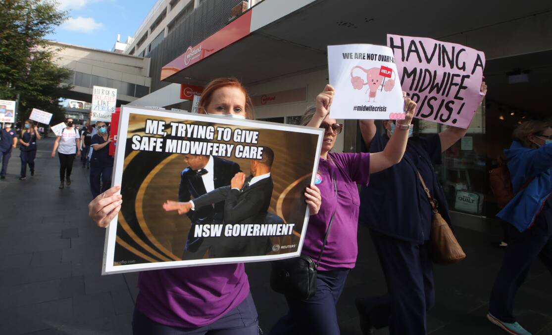 Signs of anger: Marching nurses and midwives carried placards bearing messages to the NSW Government. 
