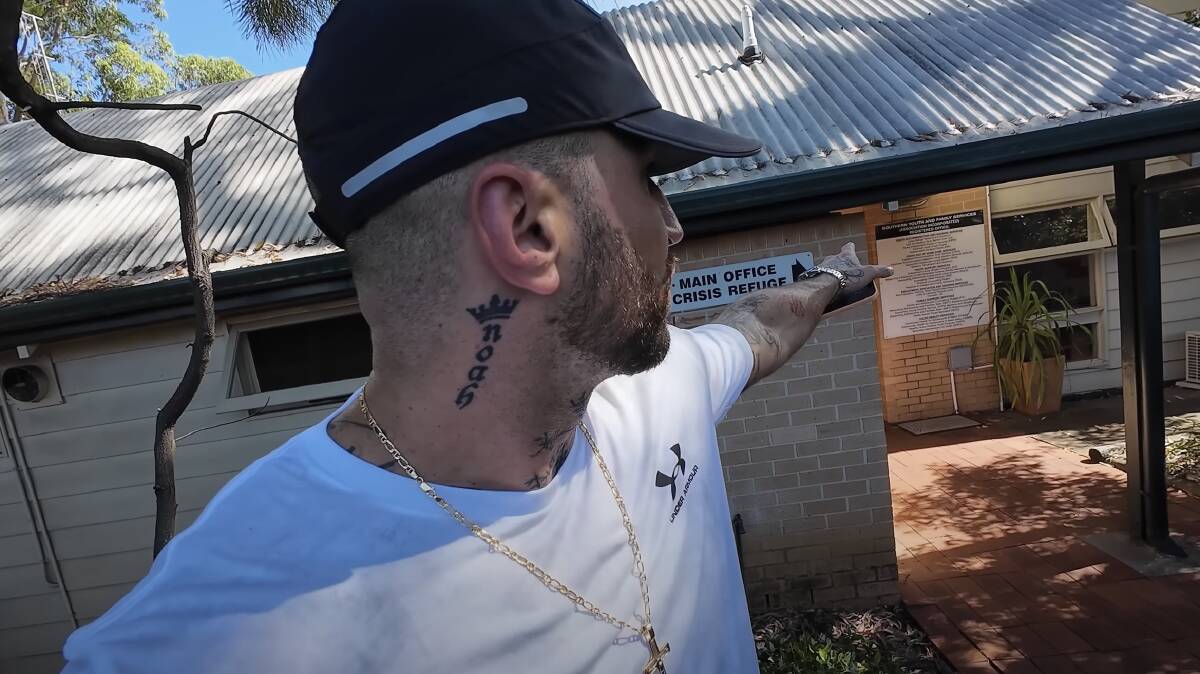 He reads from the sign outside Southern Youth and Family Service crisis service office, then ad-libs that there are "release services, stuff like that" because that fits the narrative he's telling. Screenshot from YouTube