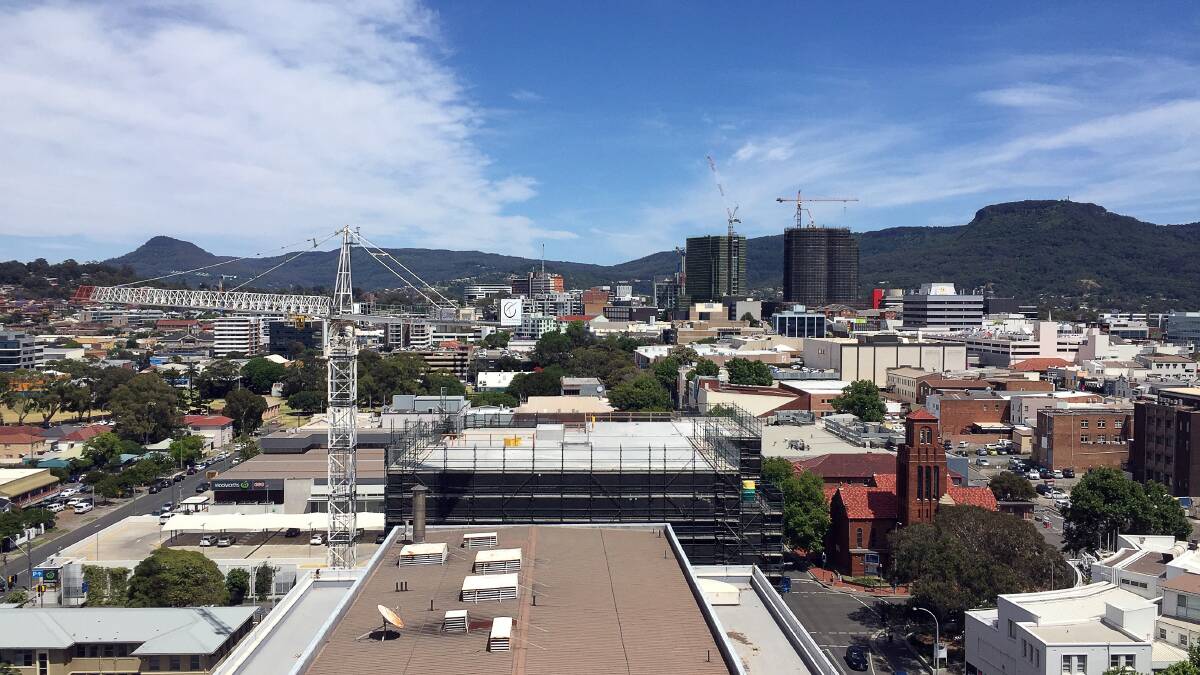 Lines of sight: Whether you look down from Mount Keira or up from the Mall, looming black scaffolding-clad rectangles dominate Wollongong's skyline and signal the new buildings which will shape the city. Picture: Robert Peet. 