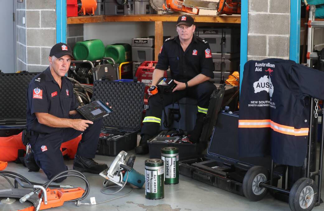 Inspector Greg Purvis and lead firefighter and Urban Search and Rescue trainer Shane Bonsall with some of the equipment the highly-trained rescue personnel will use when they arrive in Turkiye. Picture: Robert Peet.