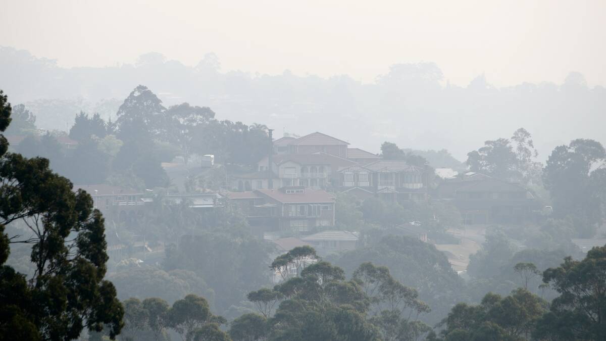 Sign of the times: Homes at Cordeaux Heights - and across the Illawarra - were once again blanketed in thick smoke from fires around NSW on Tuesday. Photo: Adam McLean.