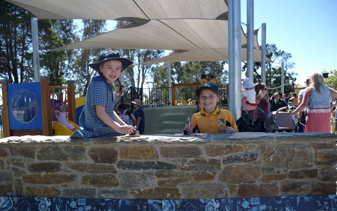 Friends Mattia Walsh, Year 1, from Holy Cross Public School, and Amily Laybutt, Year 2, from Helensburgh Primary School, enjoy the new equipment. Picture: Wollongong City Council.