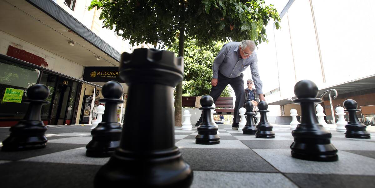 Checkmate: Chess player Peter Ruvinov tries out the council's new smaller-sized set which matches the board in Crown Street Mall. Picture: Sylvia Liber.