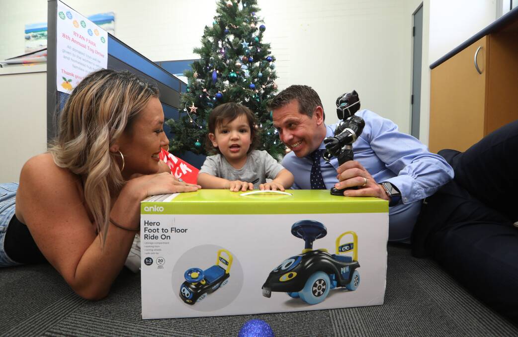 Christmas spirit: Two-year-old Santiago tests out some of the donated toys from Keira MP Ryan Park's toy drive, which will helps take the stress out of the festive season for his mum, Chynna Clayton. Picture: Robert Peet.