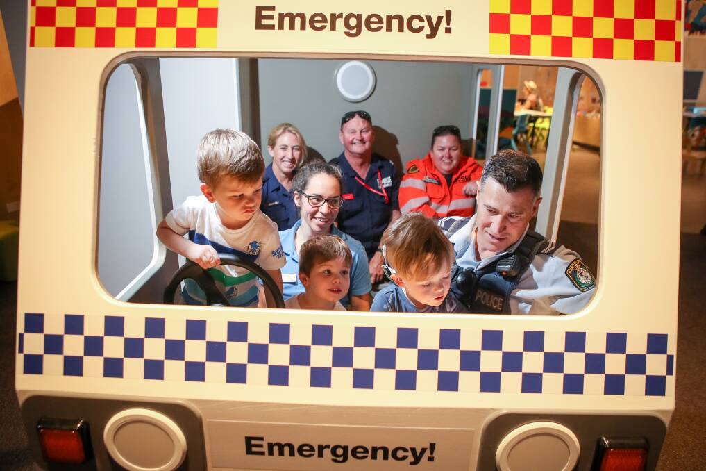 Hamish and Oscar Grose and Tyler Hardwick join emergency services workers at the new exhibit, now open at UOW's Discovery Space. Picture: Adam McLean.