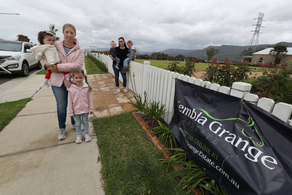 Not happy: Sandra Etryk with Sophie and Clara, and Ami Beck with Reuben and Oscar at Kembla Grange Estate, which may no longer be in the suburb of Kembla Grange if the council's name changes go ahead. Picture: Robert Peet.