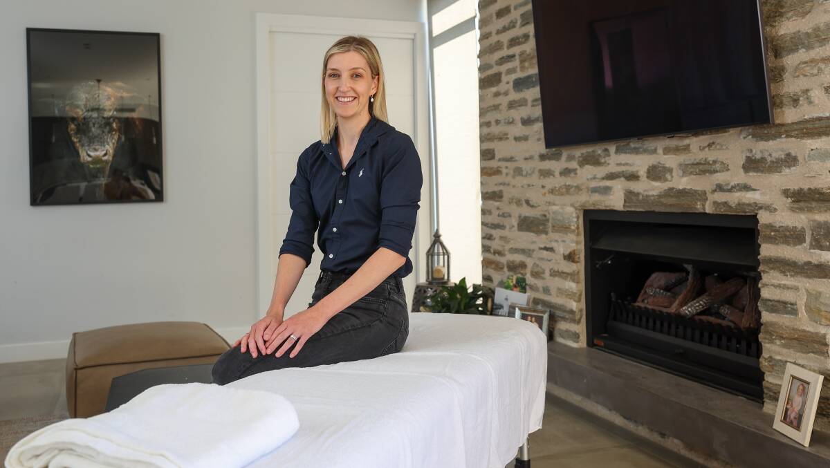 Physiotherapist Kayla Morosin sitting on a treatment table in a home environment. Picture by Adam McLean