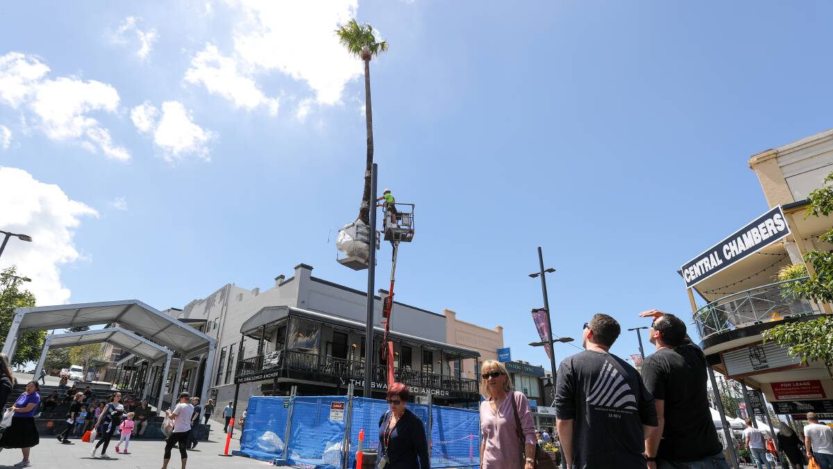 Pole-arising: Crown Street Mall shoppers craned to see the newly unveiled centrepiece of Wollongong council's public art project. Picture: Adam McLean.