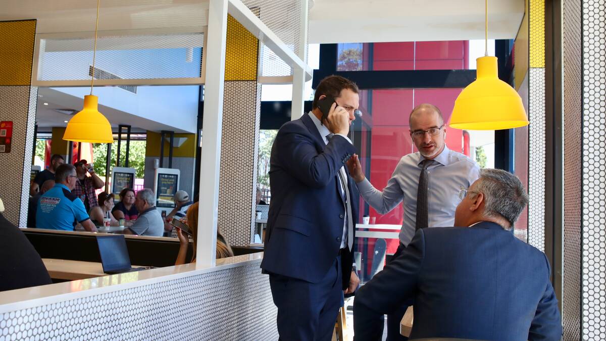 Dog fight: Greyhound Racing NSW official Tony Mestrov on the phone with Grant Carroll at Dapto McDonalds ahead of a 2pm court meeting about the lockout of greyhound racers for tonights meet at the Dapto track. Photo: Adam McLean.
