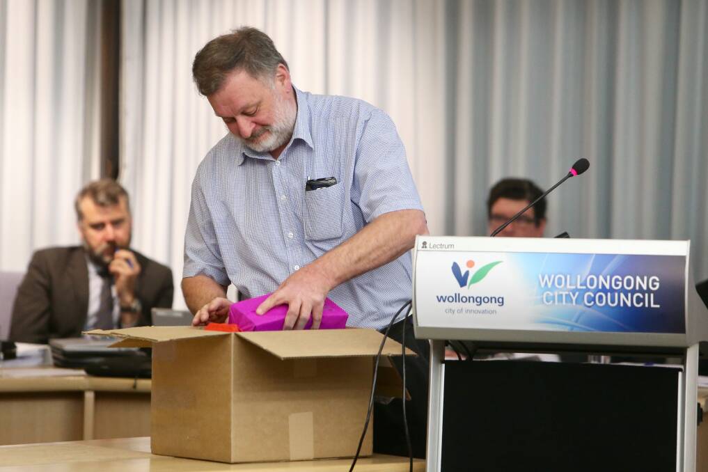 Mr Erwin gave out parting gifts to councillors. Pictures: Adam McLean.