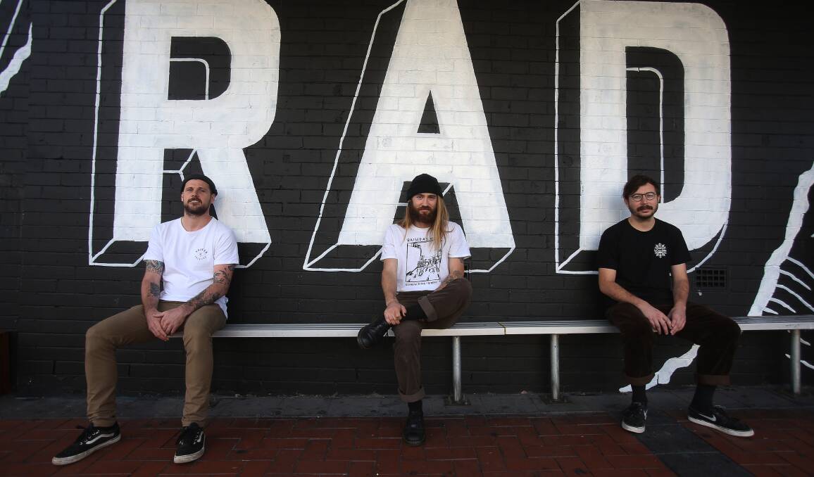 Not rad: Sion Gruffydd, Jye Talbot and Daniel Radburn outside their Kembla Street venue, which would disappear under new development plans. Picture: Robert Peet