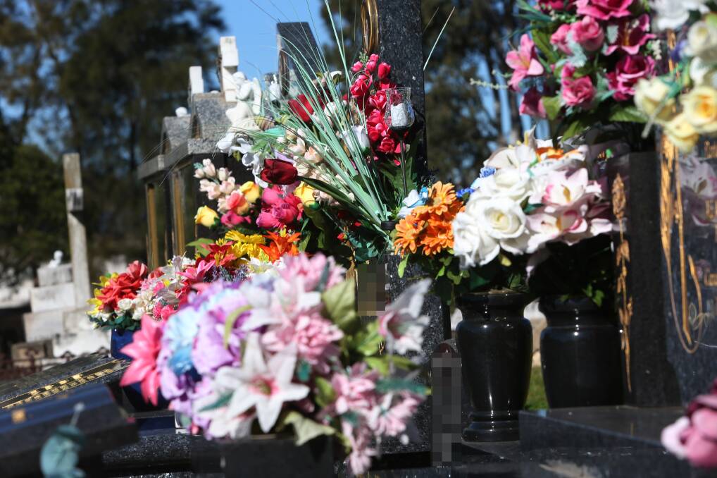 No longer allowed: Artificial flowers or excessive natural floral arrangements,or those displayed in more than two unbreakable vases will be banned under a new Shellharbour council cemetery policy. Picture: Robert Peet.