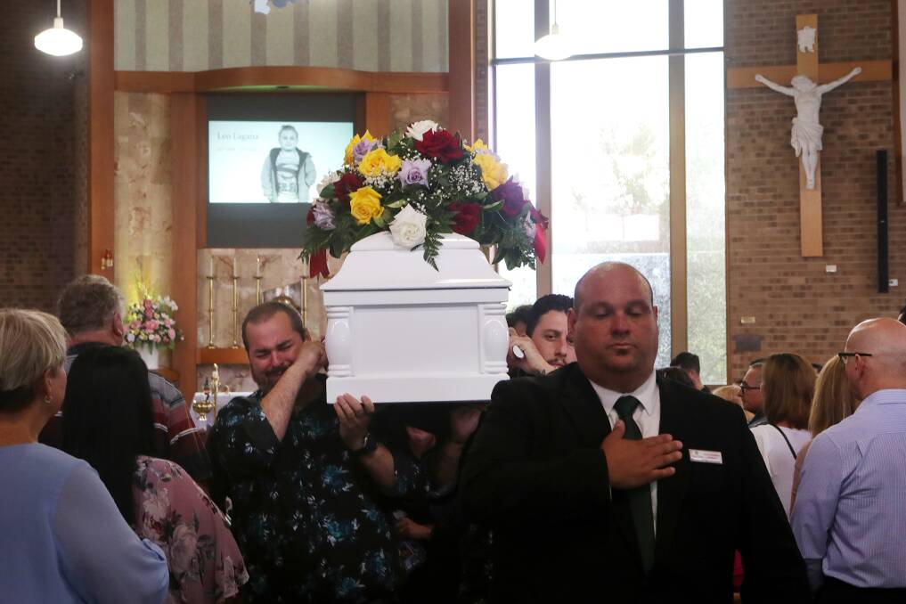 Leo's family carried his coffin, adorned with birhgt flowers, out of the church as Con Te Partiro was sung.