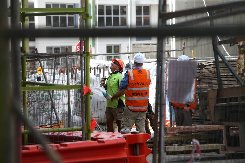 Inspectors check in with a Belmore Street building site on Monday, where they were looking at the safety of a large crane. Note: Safework and Fair Trading did not identify this site as the one which was slapped with six prohibition orders. Picture by Sylvia Liber.